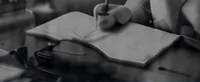 ノートに作曲のアイデアを書く人